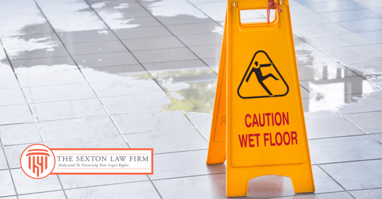 Image of a spill and a wet floor sign next to it