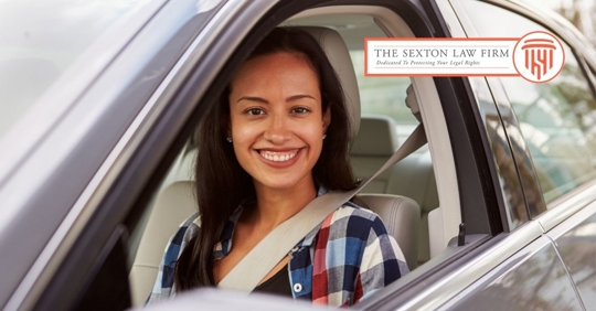 Happy Hispanic female driver in a car