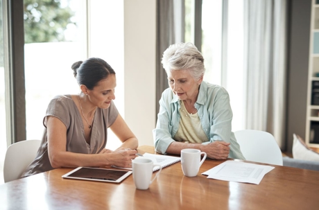Elderly woman going through her estate plan with an attorney