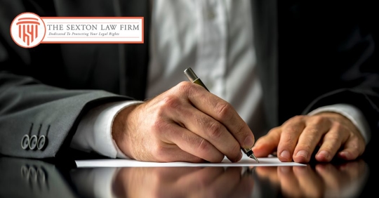 man signing a will